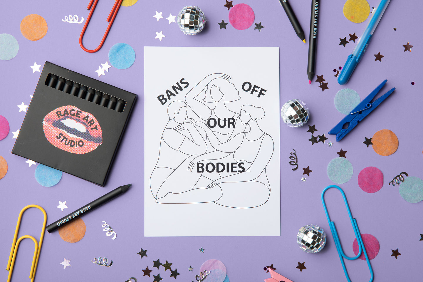 A black and white image of the "Bans Off Our Bodies" postcard. Also pictured are the 12 colored pencils that come with each kit.